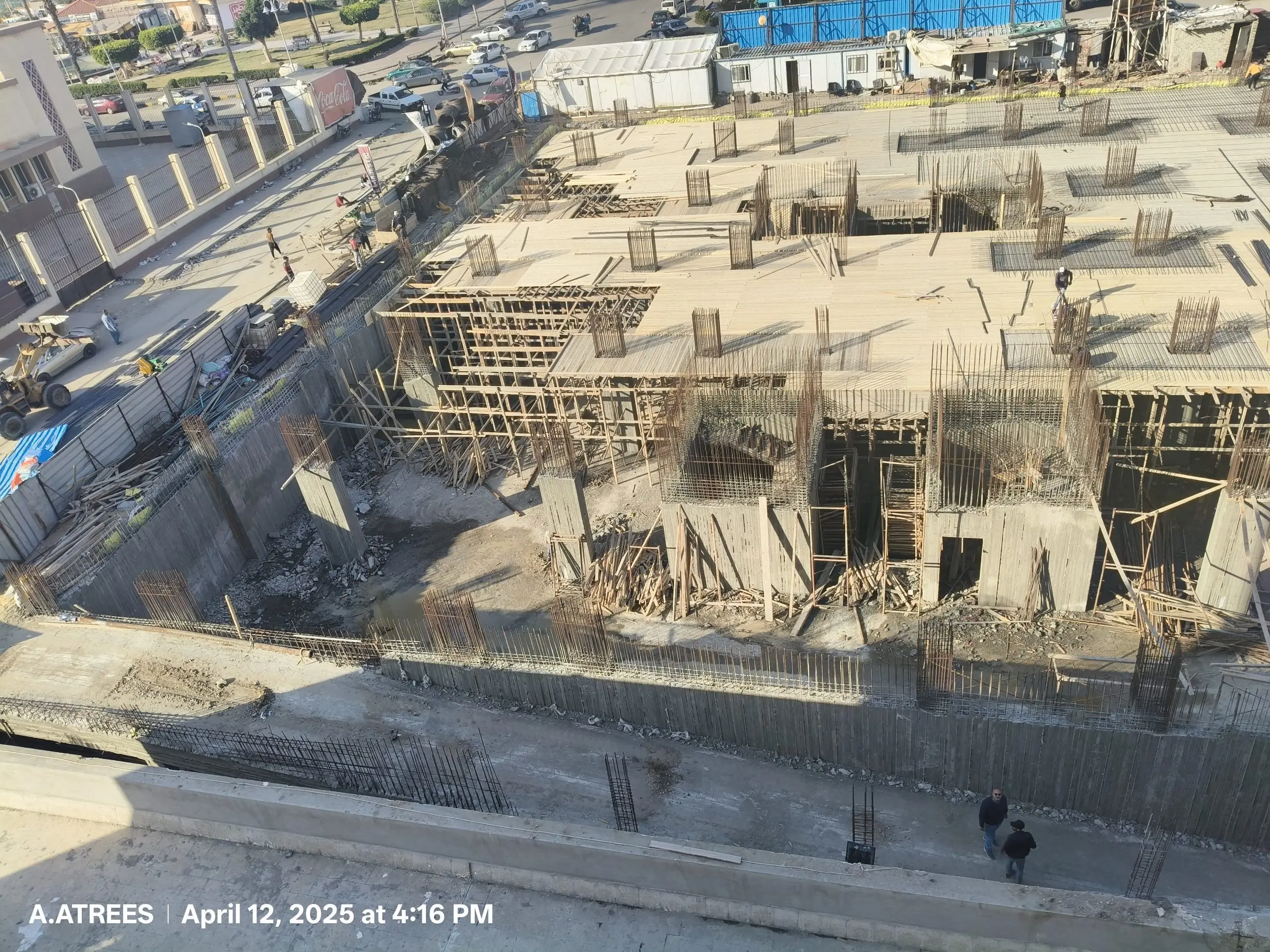 Concrete slab and rebar framework on active DiamoNest Tower construction site – موقع إنشاء نشط لبرج ديامونيست مع بلاطة خرسانية وحديد تسليح.