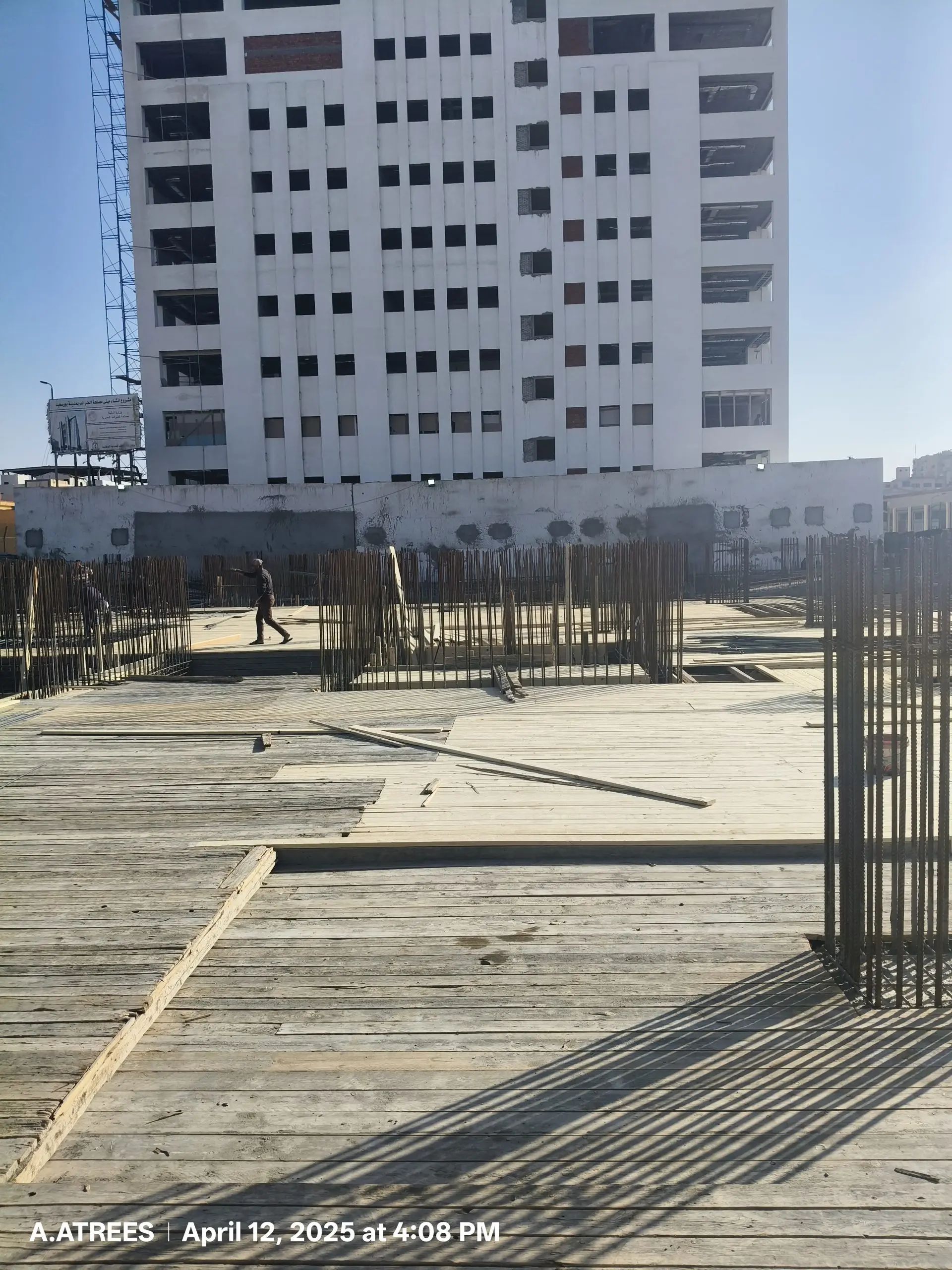 Top view of reinforcement columns and plywood decking at DiamoNest Tower construction site – منظر علوي لأعمدة التسليح وألواح الخشب في موقع بناء برج ديامونيست.