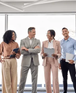 Careers team photo featuring company manager with employees in a collaborative work environment -الوظائف