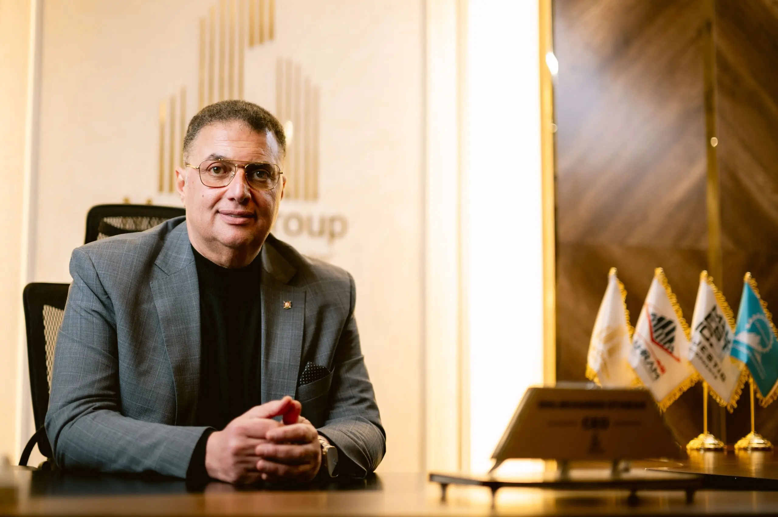 The CEO of Majestic Developments, a visionary leader in real estate development, sitting at his desk in Egypt, representing a leading real estate company.
